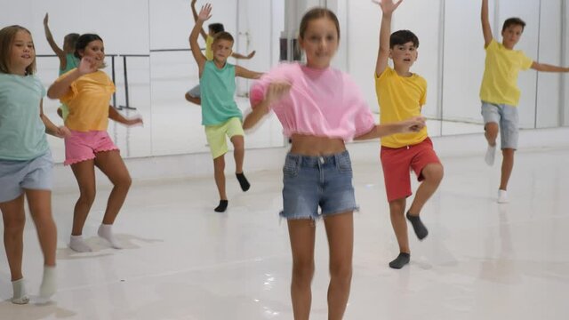Portrait of group of boys and girls having dancing class in dance studio
