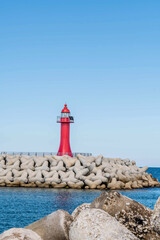 Fototapeta na wymiar One white and one red lighthouse on concrete pier