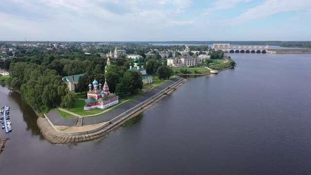 Picturesque aerial view of modern townscape of Uglich overlooking dam on Volga River on summer day, Yaroslavl region, Russia. High quality 4k footage