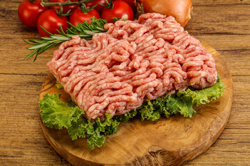 Raw pork minced meat over board