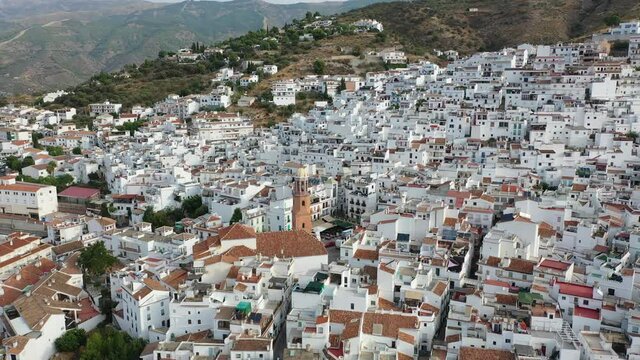 Aerial view of central areas of Competa overlooking parish Church of Assumption on sunny fall day, Andalusia, Spain. High quality 4k footage