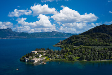 Fototapeta na wymiar Aerial view of Parco Baia delle Sirene, Lake Garda, Italy. Panorama of punta san vigilio. Top view of baia delle sirene on the coastline of Lake Garda. Baia delle Sirene on the coastline.