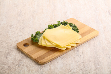 Sliced Gouda cheese over board
