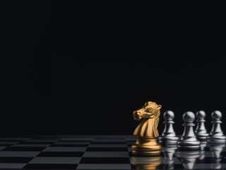The golden horse, the knight chess piece, leads the silver pawn chess pieces on dark chessboard with copy space. Leadership, influencer, follower, team, commander, and business strategy concept.