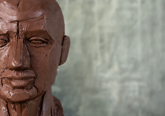 Geometric head sculpture model made from red clay with copy space. Model for art study. Art...