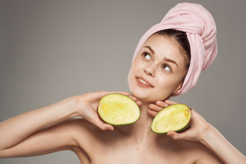 pretty woman bare shoulders clean skin mango in hand cropped view