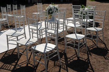 transparent chairs and a white carpet at the wedding ceremony.