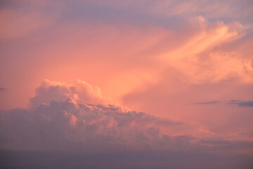 Colorful evening landscape with soft pastel coloured clouds on watercolor tinted sunset sky. Abstract nature background