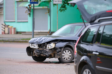 Damaged in car accident vehicle on city street crash site