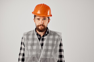 male builder with documents and drawings blueprints light background