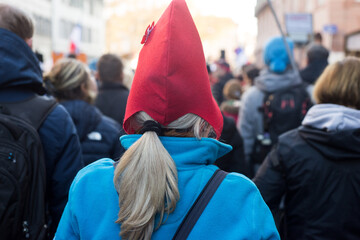 Portrait on back view of woman wearing a french revolutionary hat in the street