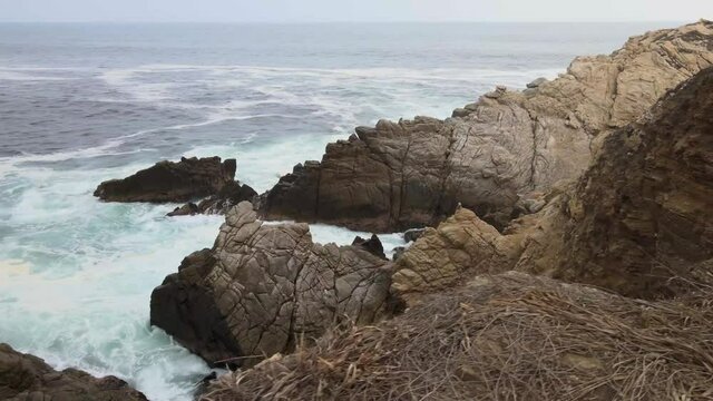 Walking side to cliff and big waves in Punta Cometa, most east site in Mexico. Mazunte Oaxaca