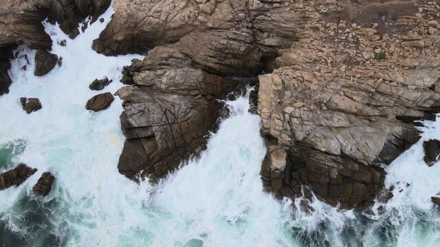 Moving left to right in cenital view above cliff and big waves in Mazunte Oaxaca