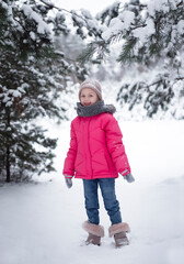 Child in winter. A little girl,  playing in the winter outside.