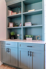 Built in cabinet with shelves drawers and doors inside living room of home © Jason
