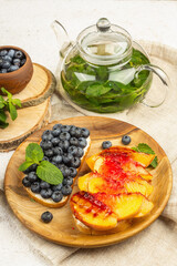 Tasty toast bread with cream cheese and ripe fruits