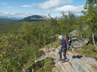 Man backpack hiker at Kungsleden trail admiring nature of Sarek in Sweden Lapland with mountains,...