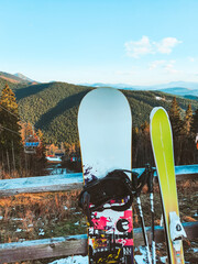 snowboard and ski mountains with skilift on background