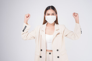 portrait of young businesswoman wearing a surgical mask over white background studio