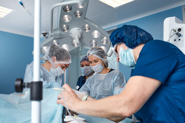 Concentrated Surgical team operating a patient in an operation theater. Well-trained anesthesiologist with years of training with complex machines follows the patient throughout the surgery