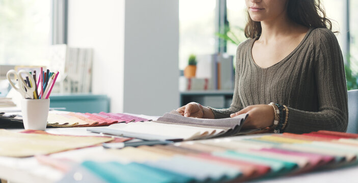 Young interior designer choosing fabric samples