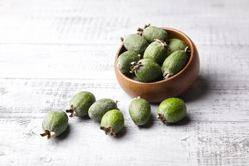 Feijoa fruits or pineapple guava in bowl on wooden table