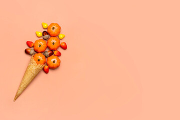 acorns, cones, pumpkins, berries in waffle cone for ice cream on orange background Top view Autumnal flat lay Holiday card