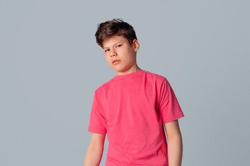 Portrait of embarrassed teenager boy, feel discomfort trying to say something with caution, standing over gray background