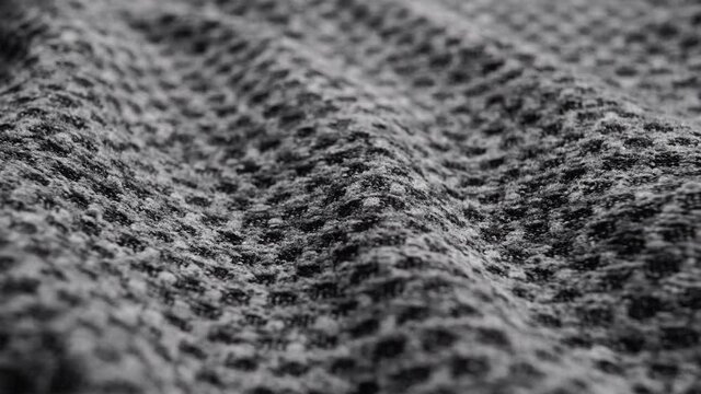 Rough gray wavy fabric texture. Wrinkled textured gray material. Abstract background. Breathable sportswear. Macro. Dolly shot