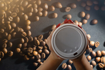 takeaway cup with coffee and coffee beans