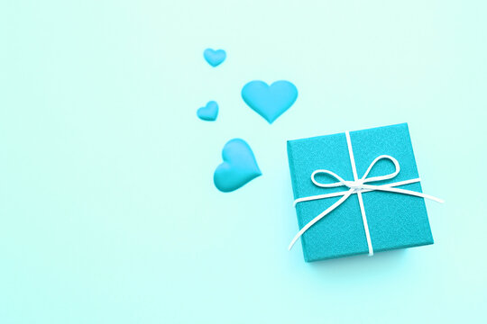 Gift boxes with hearts of light turquoise blue. Gifts for the Christmas holiday or the birthday. Love background. Copy space for text. Color Banner