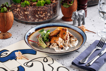 Portion of gourmet chicken fillet in cream sauce dish