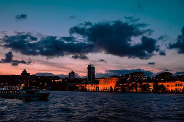 Fototapeta premium city skyline at sunset, ship sailing, cloudy sunset, turkey travel, night trip