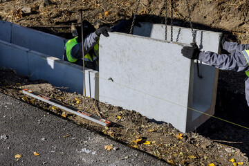 Road worker mounting U-ditch, U-shaped water channel construction