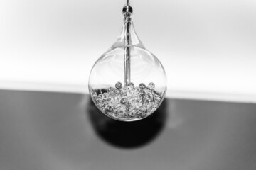 large electric lamp with glass balls inside close-up black and white photo