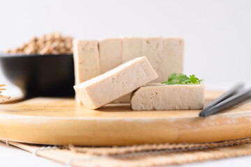 Sliced fresh tofu on wooden board, Vegan Food ingredients in Asian food