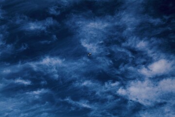 Fototapeta na wymiar Blue sky with clouds and an aeroplane.