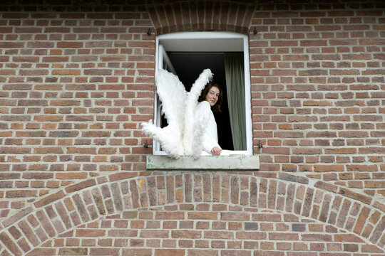 Angel smiling on window sill