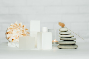 A composition of items for a spa salon. Beauty treatments and massages. Stones representing the balance of feng shui. Close-up, copy space, white background.