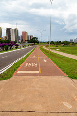 Brasília DF, Brazil, November 7, 2021: Signposted cycle path in the square of the TV tower next to the hotel sector in the central region of Brasília. In the background, the esplanade of the ministrie