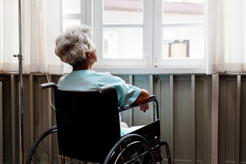 Fototapeta na wymiar Old woman on a wheel chair
