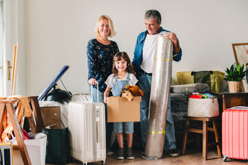 Cheerful family moving into a new house