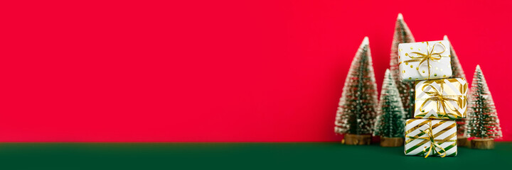 White gift boxes with golden bow isolated on red background. Online christmas shopping and sale. Copy space. Banner