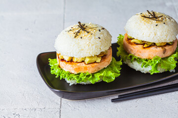Rice burger with salmon cutlet, avocado and soy sauce,