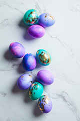 Easter eggs purple and blue with golds on marble background.