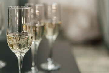 Close-up of champagne glasses in a row on the table. Copy space.