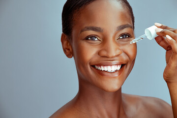 Black beauty woman dropping collagen serum moisturizer on face