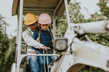 Father teaching daughter at a construction site - obrazy, fototapety, plakaty
