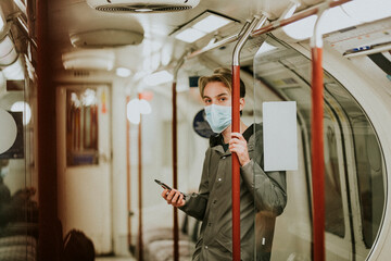 Fototapeta na wymiar Man using a phone on a train in the new normal