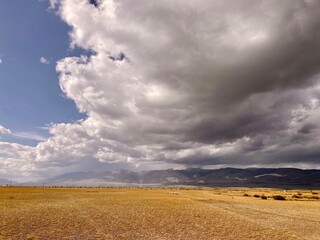 Steppe against the background of the Altai mountains on a beautiful cloudy day.